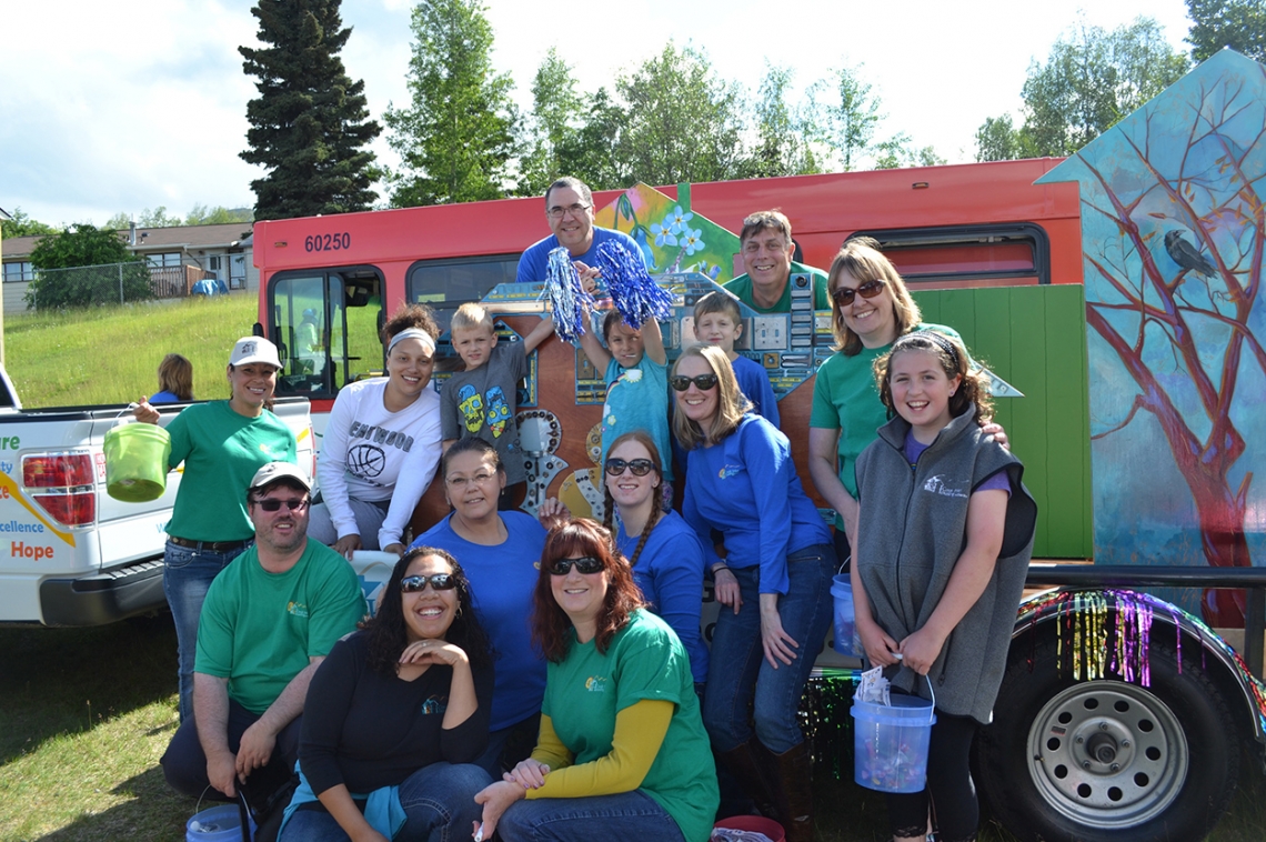 Cook Inlet Housing Authority staff and family members at the Bear Paw Festival.  Local artists collaborated on a float to draw attention to CIHA’s #housingmatters campaign. Photo: ArtPlace America website.