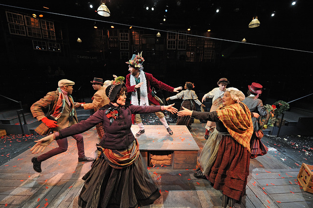 Orlando Hernandez (center) as Ghost of Christmas Present with the company of “A Christmas Carol,” directed by Angela Brazil and Stephen Thorne. Costume design by Toni Spadafora, set design by Michael McGarty, lighting design by Dawn Chiang. Photo by Mark Turek.