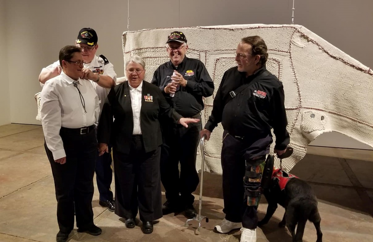 American Veterans for Equal Rights (AVER) with the Humvee Cozee by artist/activist Shirley Klinghoffer, the focal point of the Love Armor 10th Anniversary exhibit at the CCA in Santa Fe. Photo by Susan M. Saloom/National Initiative for Arts & Health in the Military.