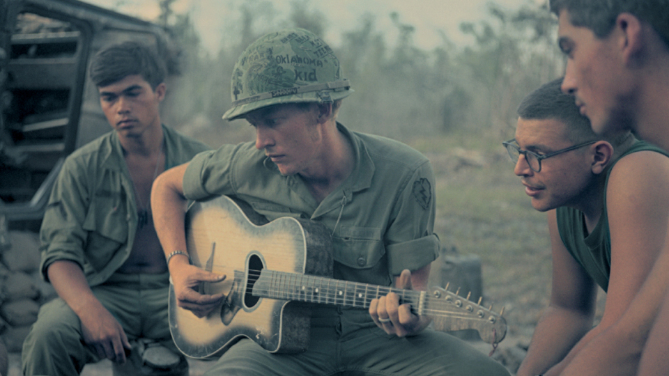 Soldiers gather around a guitar in Vietnam. (Photo: National Public Radio)
