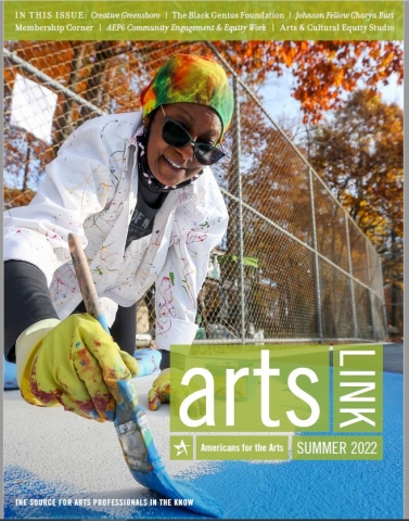 The cover of the Spring 2022 issue of Arts Link, depicting a person in sunglasses, gloves, a bandana, and a white painters coat, painting blue on a mural on the ground.